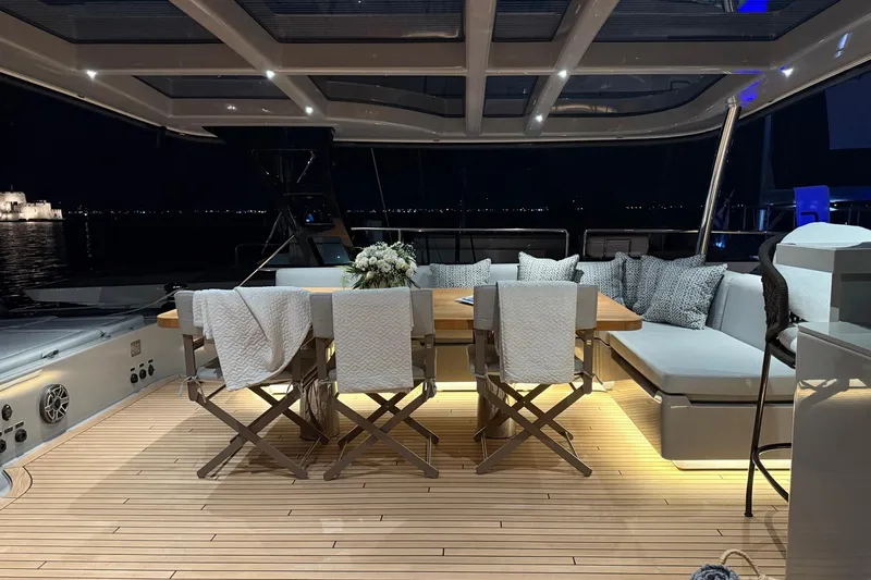 Serenity Yacht Photos Pics Luxurious 2024 Sunreef 60 yacht interior with elegant dining area at night.
