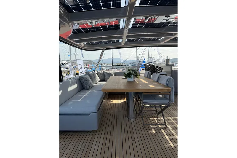 Serenity Yacht Photos Pics Luxurious Sunreef 60 yacht deck with elegant seating and dining area, 2024 model.