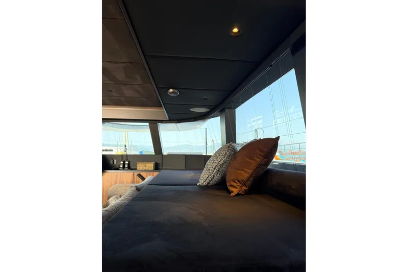 Serenity Yacht Photos Pics Luxurious interior of 2024 Sunreef 60 yacht with plush seating and panoramic windows.