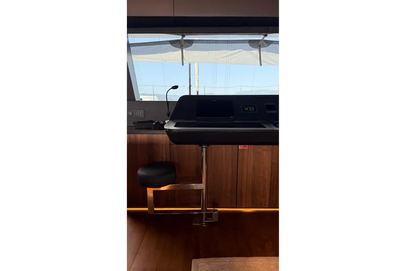 Serenity Yacht Photos Pics Luxurious interior of 2024 Sunreef 60 yacht with modern helm station and seating.