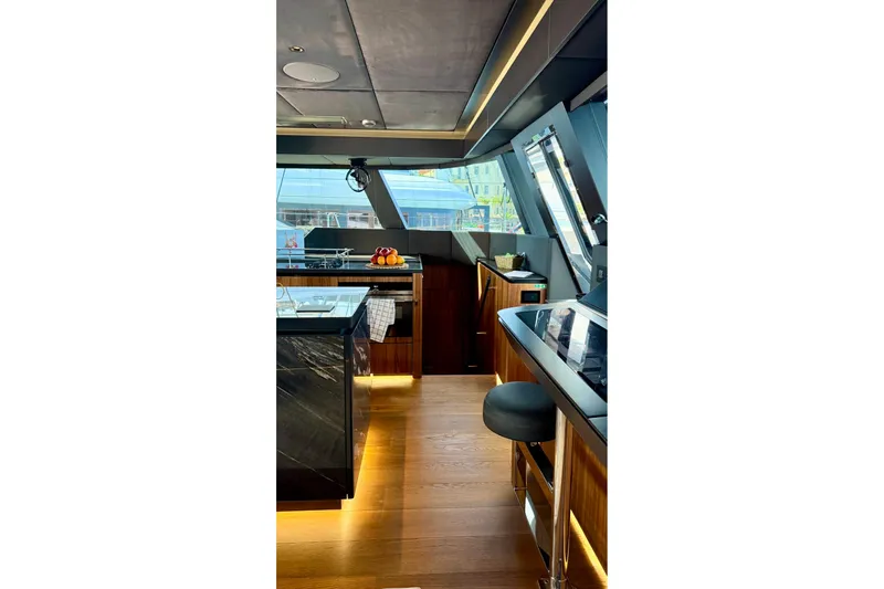 Serenity Yacht Photos Pics Luxurious interior of 2024 Sunreef 60 yacht with modern kitchen design.
