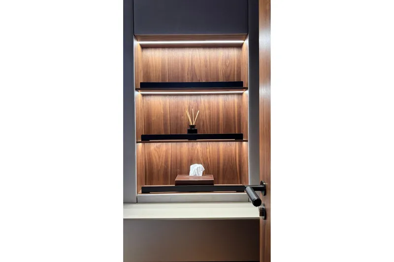 Serenity Yacht Photos Pics Luxurious wooden shelving with ambient lighting on a 2024 Sunreef 60 yacht.