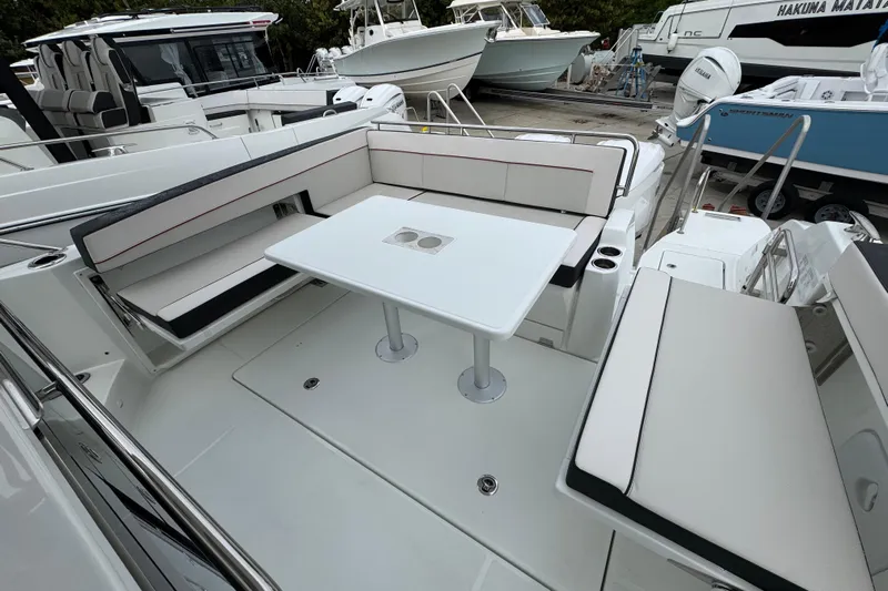  Yacht Photos Pics 2025 Jeanneau Leader 10.5 WA Series 2 boat interior with seating and table.