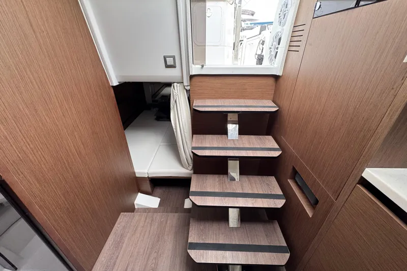  Yacht Photos Pics 2025 Jeanneau Leader 10.5 WA Series 2 interior with wooden stairs and cozy cabin.