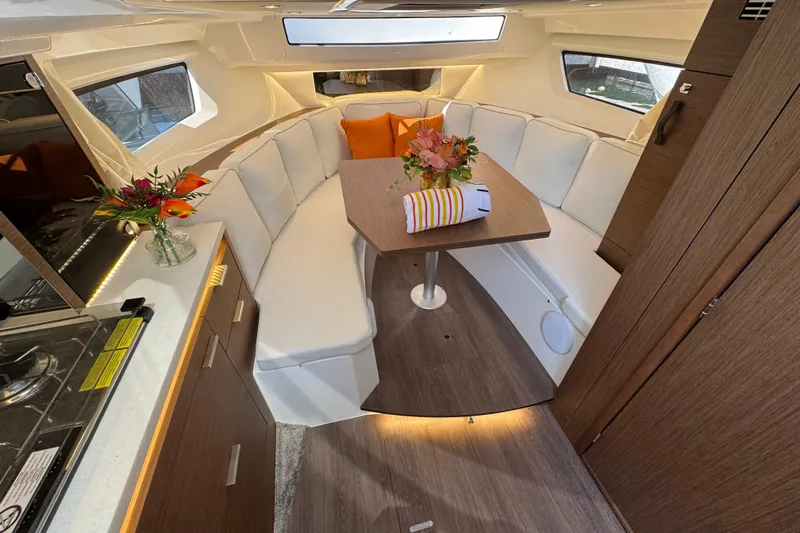  Yacht Photos Pics Interior of 2025 Jeanneau Leader 10.5 WA Series 2 with elegant seating and dining area.