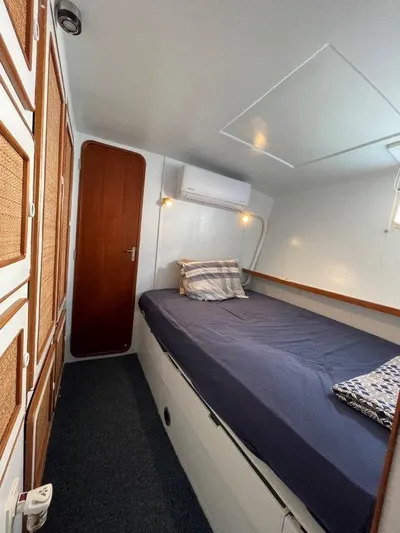 Ps 70 Yacht Photos Pics Cozy cabin interior of 1990 Shuttleworth BLUE PEGASUS 70 with bed and wooden accents.