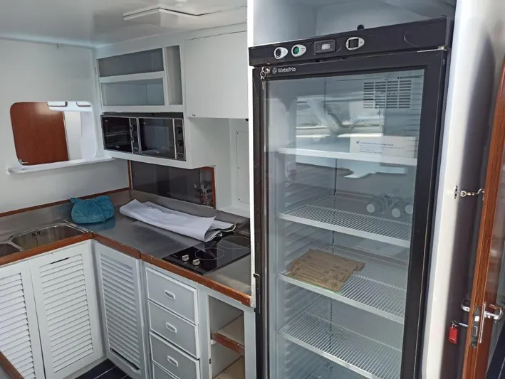 Ps 70 Yacht Photos Pics Modern yacht kitchen with stainless steel counters, empty fridge, and microwave. Shuttleworth BLUE PEGASUS 70, 1990.