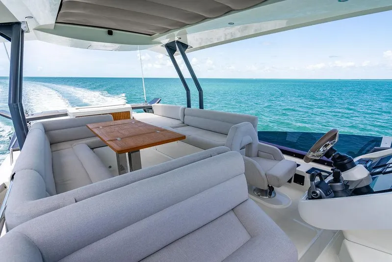 Grace Yacht Photos Pics Luxurious 2022 Beneteau Monte Carlo 52 yacht interior with ocean view and elegant seating.
