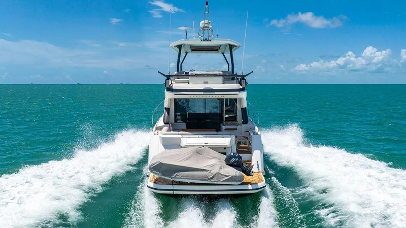 Grace Yacht Photos Pics 2022 Beneteau Monte Carlo 52 yacht cruising on open sea under clear blue sky.