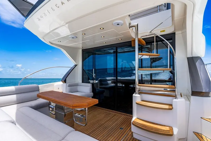 Grace Yacht Photos Pics Luxurious 2022 Beneteau Monte Carlo 52 yacht deck with elegant seating and ocean view.