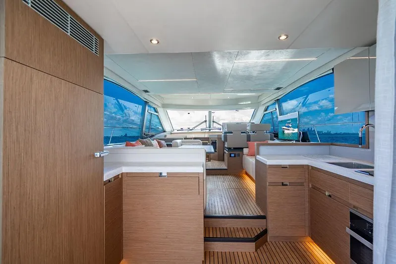 Grace Yacht Photos Pics Luxurious interior of 2022 Beneteau Monte Carlo 52 yacht with modern wood finishes and panoramic windows.