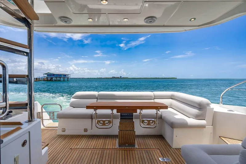 Grace Yacht Photos Pics Luxurious 2022 Beneteau Monte Carlo 52 yacht with elegant deck seating and ocean view.