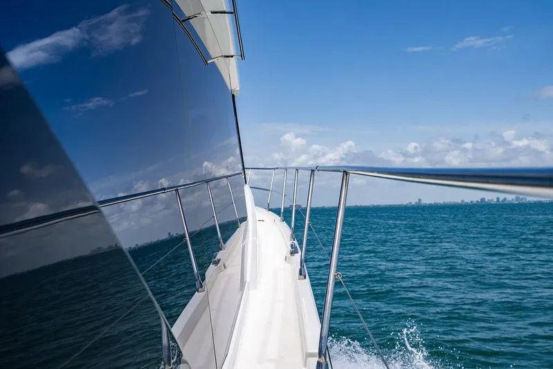 Grace Yacht Photos Pics 2022 Beneteau Monte Carlo 52 yacht cruising on open sea under clear blue sky.