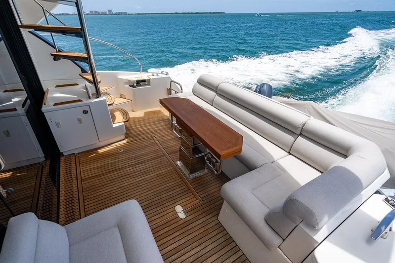 Grace Yacht Photos Pics Luxurious 2022 Beneteau Monte Carlo 52 yacht deck with elegant seating and ocean view.