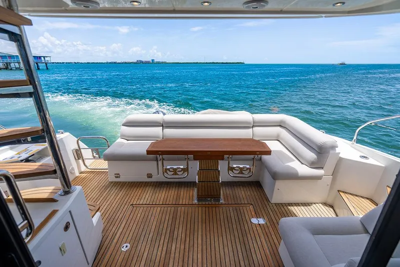 Grace Yacht Photos Pics Luxurious 2022 Beneteau Monte Carlo 52 yacht deck with ocean view and elegant seating.