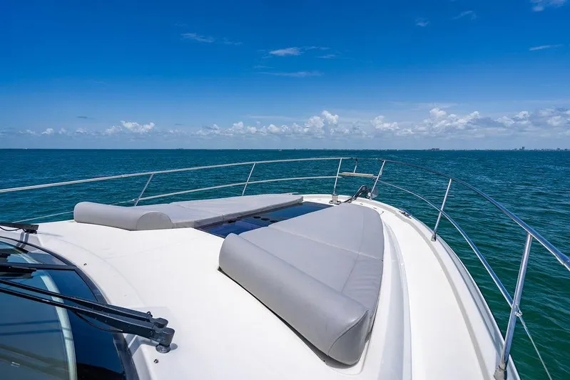 Grace Yacht Photos Pics Beneteau Monte Carlo 52 yacht deck with sun loungers, 2022 model, on open sea.