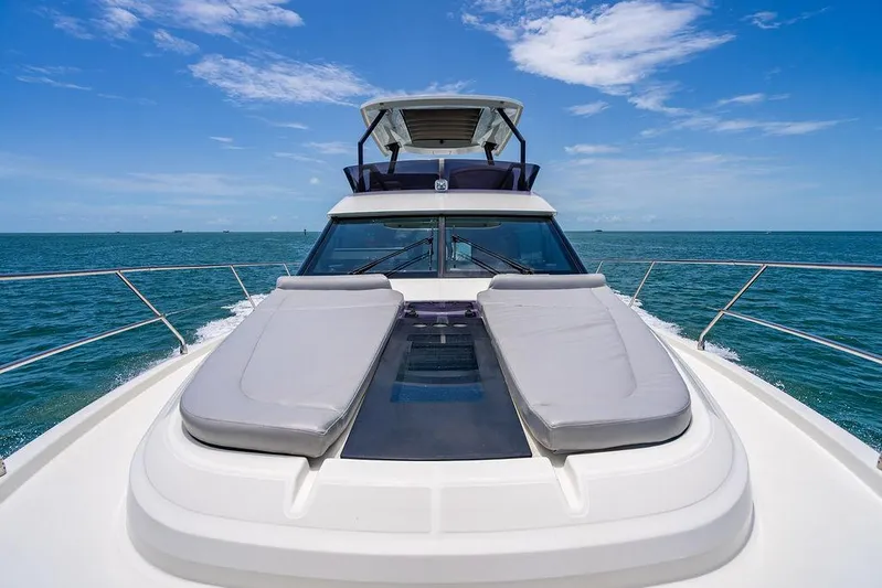 Grace Yacht Photos Pics 2022 Beneteau Monte Carlo 52 yacht on open sea, featuring sun loungers and sleek design.