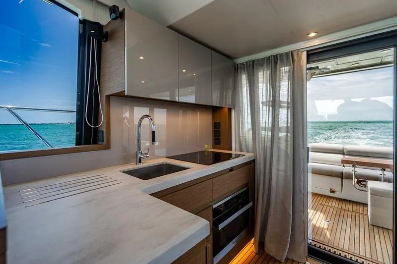 Grace Yacht Photos Pics Modern kitchen interior on 2022 Beneteau Monte Carlo 52 yacht, featuring sleek design and ocean view.