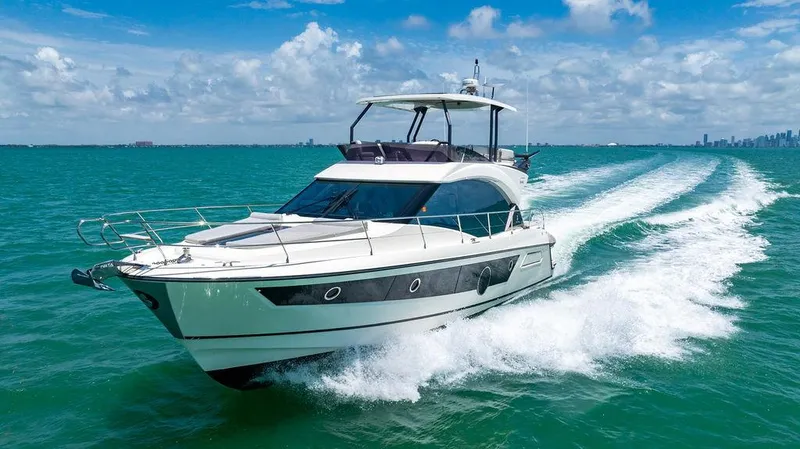 Grace Yacht Photos Pics 2022 Beneteau Monte Carlo 52 yacht cruising on turquoise ocean waters.