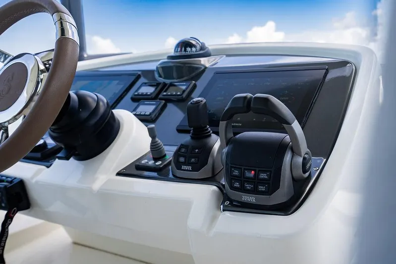 Grace Yacht Photos Pics Control panel of 2022 Beneteau Monte Carlo 52 yacht with steering wheel and navigation instruments.