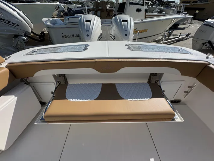  Yacht Photos Pics 2025 Regulator 31 boat interior with tan seating and dual outboard engines.