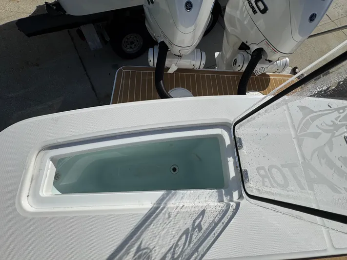  Yacht Photos Pics 2025 Regulator 31 boat with open livewell and twin outboard engines.