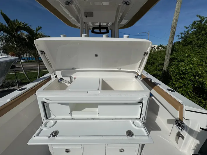  Yacht Photos Pics 2025 Regulator 31 boat with open storage compartments and sleek design.