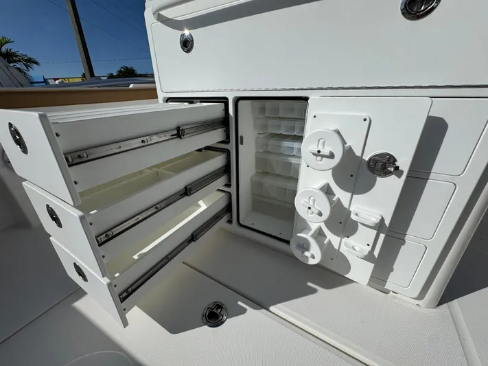  Yacht Photos Pics 2025 Regulator 31 boat storage compartments with open drawers and tackle storage.
