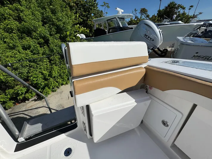  Yacht Photos Pics 2025 Regulator 31 boat interior with tan and white seating, outdoor setting.