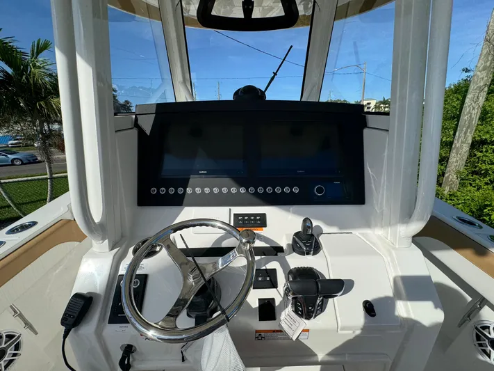 Yacht Photos Pics 2025 Regulator 31 boat helm with steering wheel and control panel.