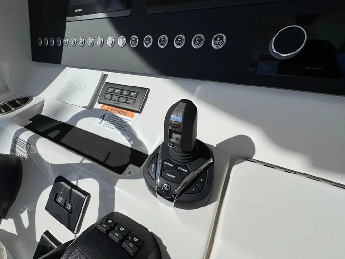  Yacht Photos Pics Control panel of 2025 Regulator 31 boat with joystick and buttons.