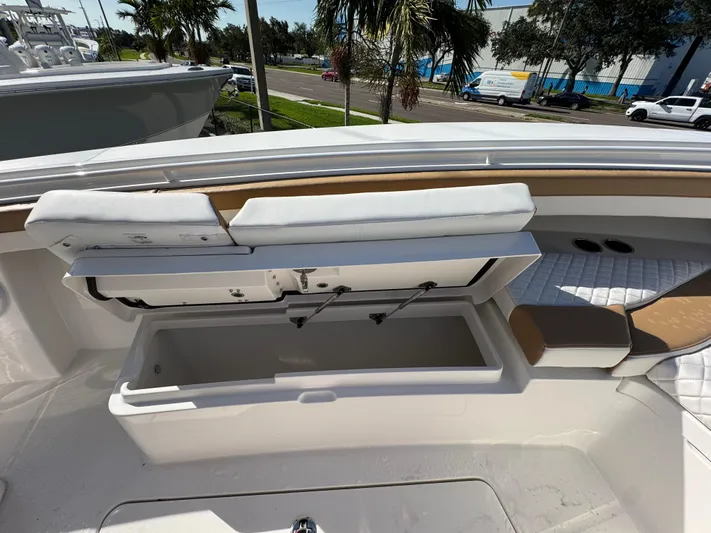  Yacht Photos Pics 2025 Regulator 31 boat with open storage compartment and cushioned seating.