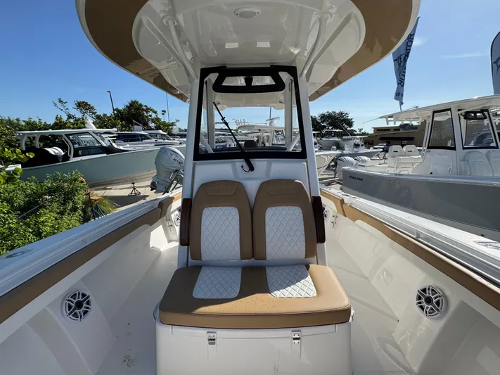  Yacht Photos Pics 2025 Regulator 31 boat interior with cushioned seating and modern design.