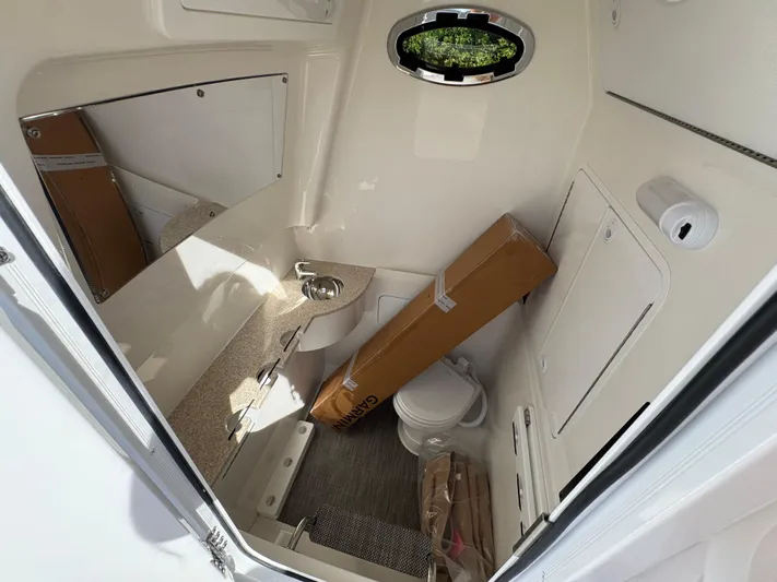  Yacht Photos Pics 2025 Regulator 31 boat interior with sink, toilet, and storage space.