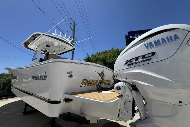  Yacht Photos Pics 2025 Regulator 31 boat with Yamaha XTO Offshore engine, docked under clear blue sky.