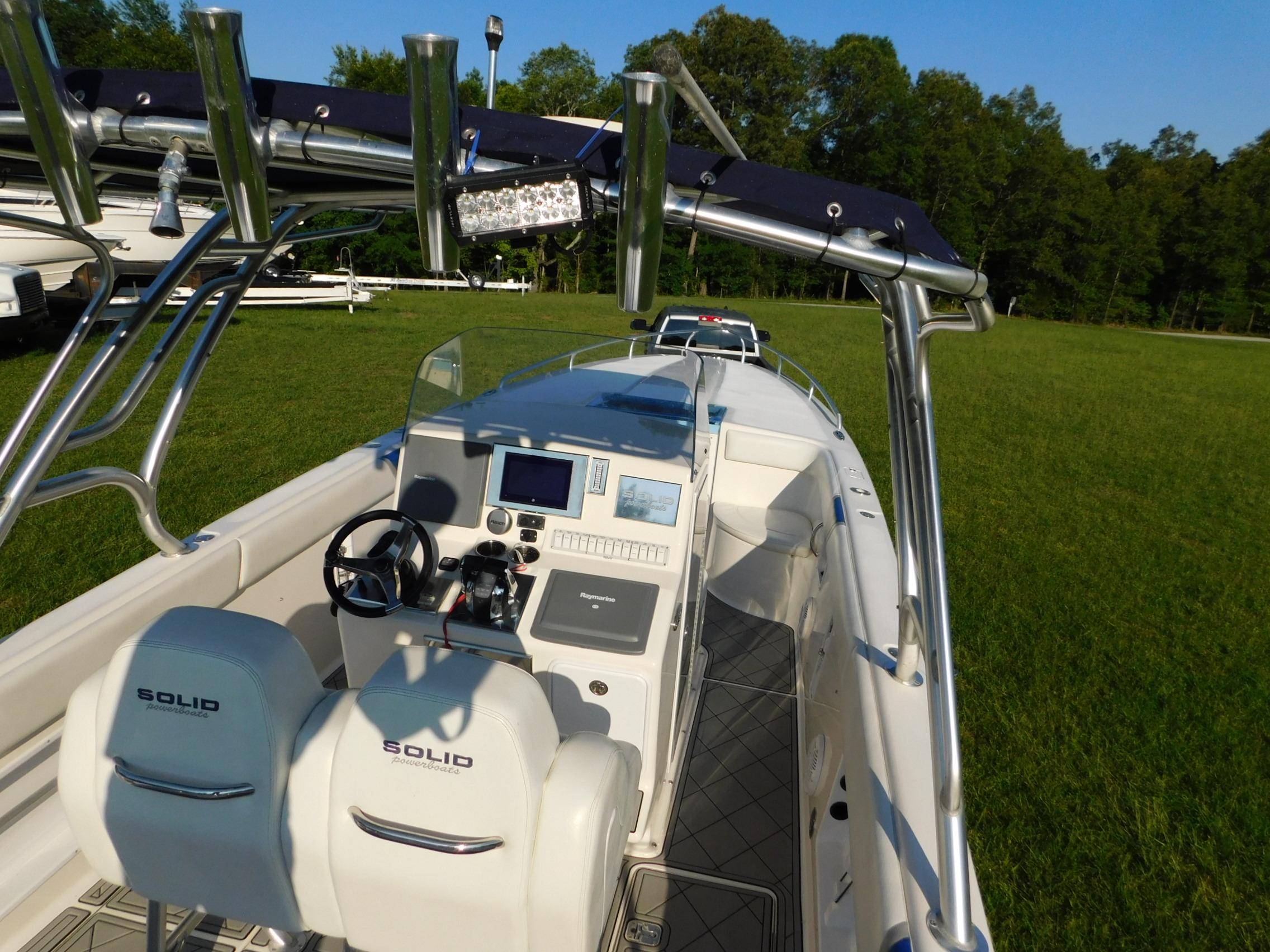 2005 Solid Craft LIMITED 40 boat with dual seats and control panel, set on grassy field.