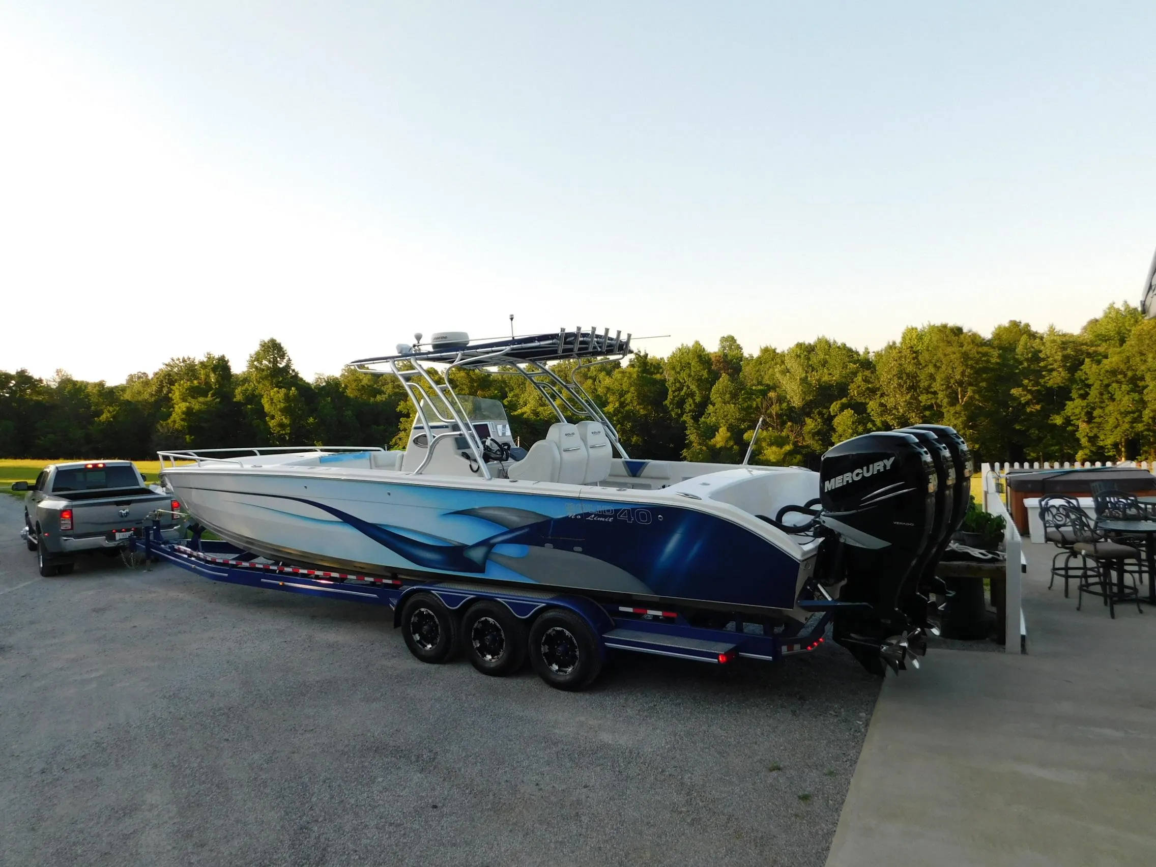 2005 Solid Craft LIMITED 40 boat on trailer, parked outdoors with scenic background.