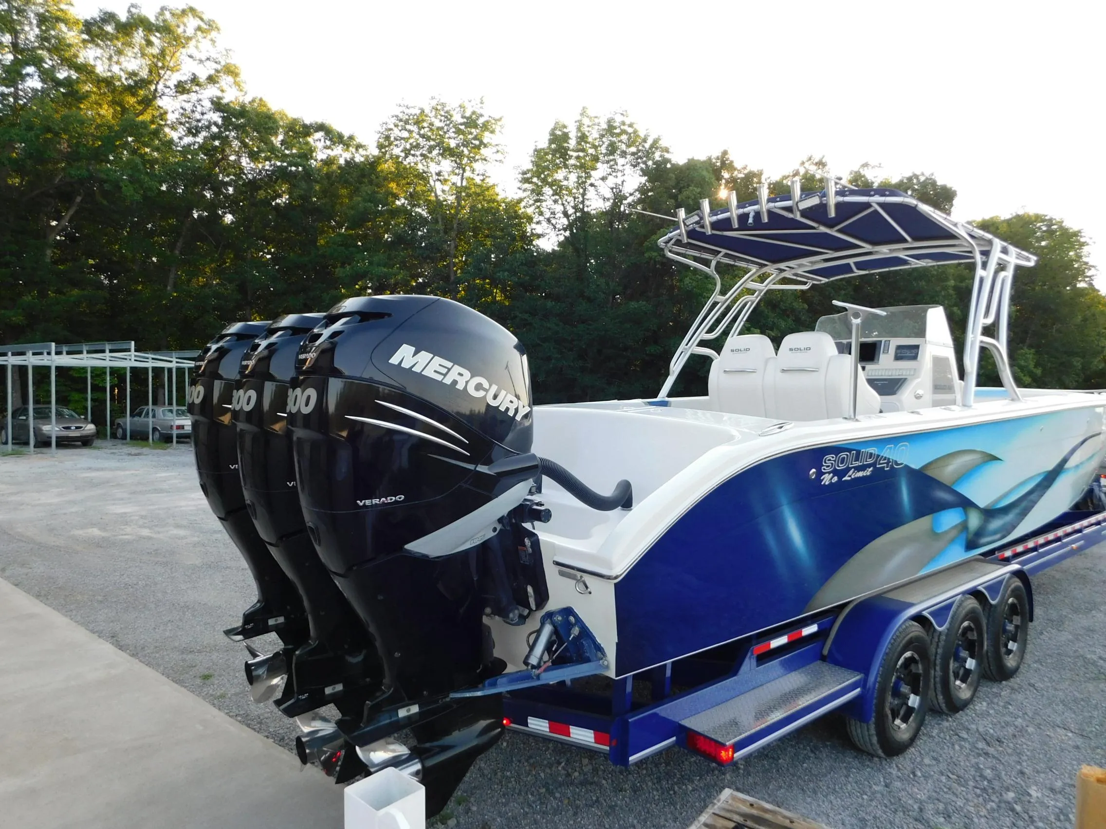 2005 Solid Craft LIMITED 40 boat with triple Mercury outboard engines on a trailer.