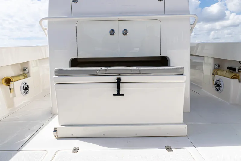  Yacht Photos Pics 2022 SeaVee 370z boat deck with storage compartment and cushioned seating.