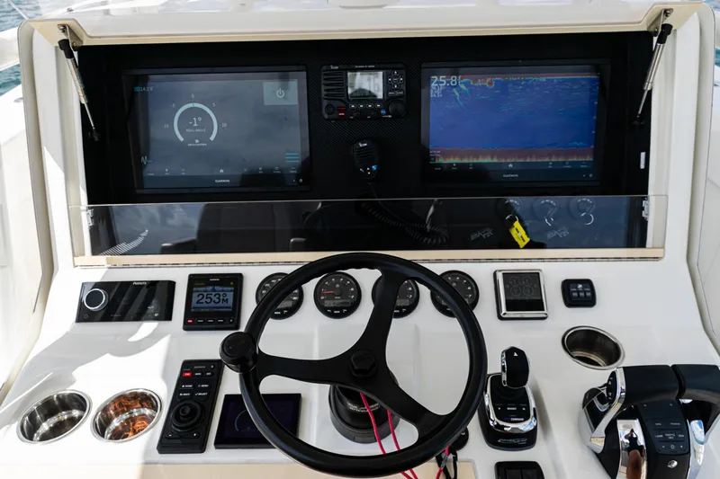  Yacht Photos Pics Control panel of 2022 SeaVee 370z boat with steering wheel and navigation screens.