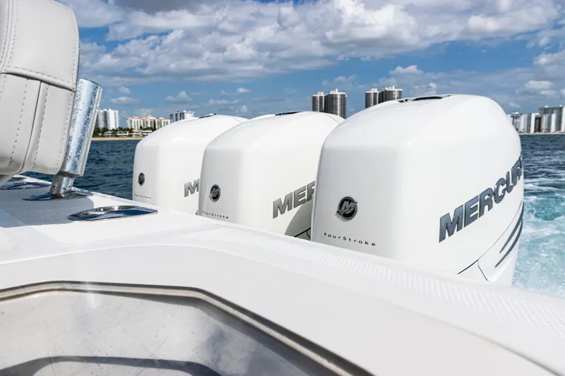  Yacht Photos Pics 2022 SeaVee 370z boat with triple Mercury engines cruising on water.