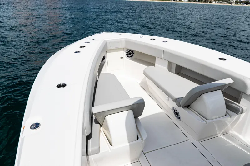  Yacht Photos Pics 2022 SeaVee 370z boat with spacious seating, cruising on calm waters.