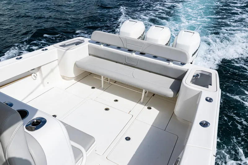  Yacht Photos Pics 2022 SeaVee 370z boat deck with seating and triple engines on the ocean.