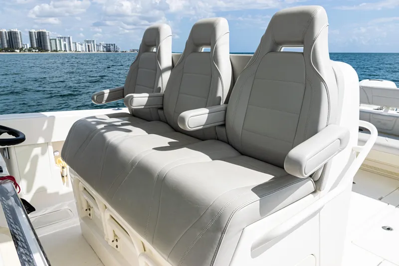  Yacht Photos Pics Three comfortable seats on a 2022 SeaVee 370z boat, with ocean and city skyline in background.