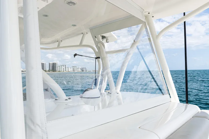  Yacht Photos Pics 2022 SeaVee 370z boat on ocean, city skyline in background, clear skies.