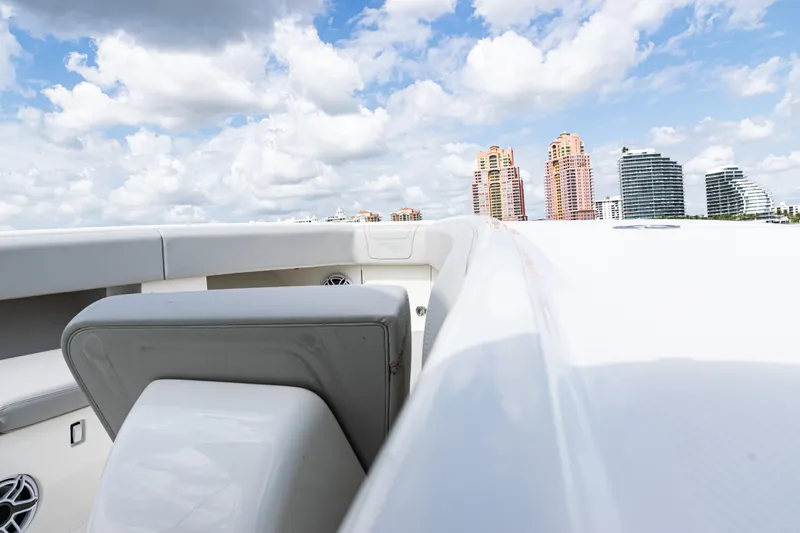  Yacht Photos Pics 2022 SeaVee 370z boat with city skyline and cloudy sky background.