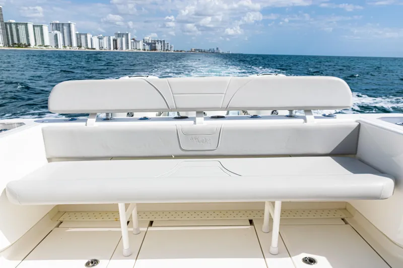  Yacht Photos Pics 2022 SeaVee 370z boat with rear seating, ocean view, and city skyline in the background.