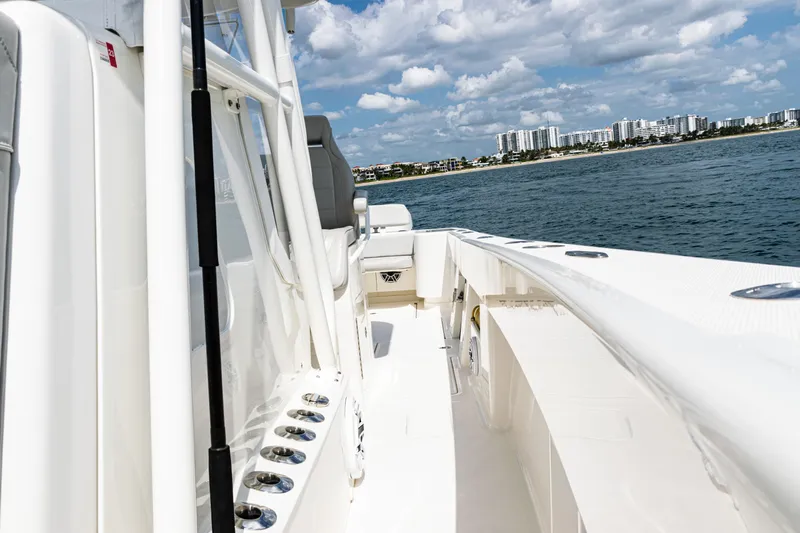  Yacht Photos Pics 2022 SeaVee 370z boat cruising on a sunny day with city skyline in background.