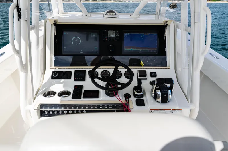  Yacht Photos Pics 2022 SeaVee 370z boat dashboard with steering wheel and navigation screens.