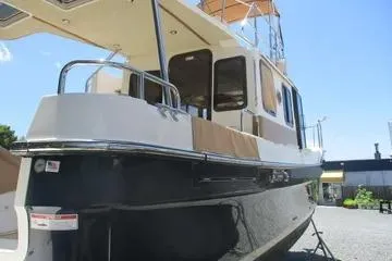  Yacht Photos Pics 2021 Ranger Tugs R-31 CB boat, docked, side view under clear blue sky.